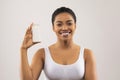 Cheerful young african american woman holding deodorant in her hand Royalty Free Stock Photo