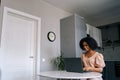 Cheerful young African American woman using laptop computer, chatting with friends online in social network, answering Royalty Free Stock Photo