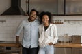 Cheerful young african family couple embrace at stylish home kitchen Royalty Free Stock Photo