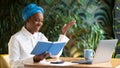 Cheerful young african woman attending online business meeting, cafe interior Royalty Free Stock Photo