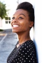 Cheerful young afro american woman leaning to a wall Royalty Free Stock Photo