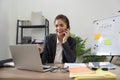 Cheerful young asian business woman talking on phone working in office. Happy positive Asian businesswoman company Royalty Free Stock Photo