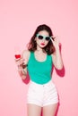 Cheerful young asian woman raising glass of wine