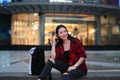 Young Asian woman sitting on stairs in city at night. Royalty Free Stock Photo