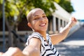 Carefree bald woman dancing on street