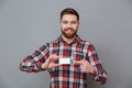 Cheerful young bearded man with copyspace business card Royalty Free Stock Photo