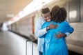 Cheerful Young Black Man Hugging Girlfriend After Train Arrival At Railway Station Royalty Free Stock Photo