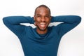 Cheerful young black man posing with hands behind head against white background Royalty Free Stock Photo