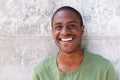 Cheerful young black man smiling against wall Royalty Free Stock Photo