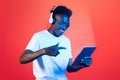 Cheerful young black man using headset and digital tablet Royalty Free Stock Photo