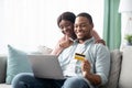 Cheerful young black man and woman shopping online, copy space Royalty Free Stock Photo