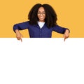 Black woman with big smile pointing to blank space for text Royalty Free Stock Photo