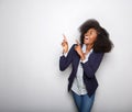 Cheerful young black woman pointing fingers against gray background Royalty Free Stock Photo