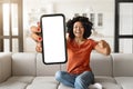 Cheerful Young Black Woman Pointing At Smartphone With Big Blank White Screen Royalty Free Stock Photo