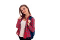 Cheerful young brunette student with blue backpack on her shoulders smiling on camera isolated on white background Royalty Free Stock Photo