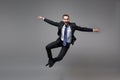 Cheerful young business man in classic black suit shirt tie posing isolated on grey background. Achievement career