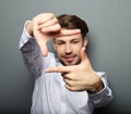 Cheerful young business man gesturing finger frame Royalty Free Stock Photo