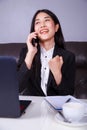 Cheerful business woman sitting at the desk and talking on mobil Royalty Free Stock Photo