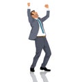 Cheerful young businessman celebrating success, handsome manager in suit and tie raising hands up and screaming