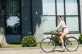 Businesswoman riding bicycle near modern building Royalty Free Stock Photo