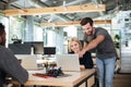 Cheerful young colleagues sitting in office coworking Royalty Free Stock Photo