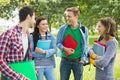 Cheerful young college students in park