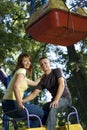Cheerful young couple on the carousel Royalty Free Stock Photo