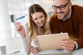 Cheerful young couple doing online shopping with tablet Royalty Free Stock Photo