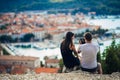 Cheerful young couple having a field trip date.Cityscape sightseeing,seaside travel vacation.Traveling in Europe