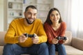 Cheerful Young Couple Having Fun At Home, Playing Video Games Together Royalty Free Stock Photo