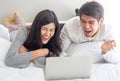 Cheerful young couple laughing at watching online movie together. Royalty Free Stock Photo