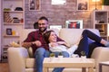 Cheerful young couple laughing while watching a tv show Royalty Free Stock Photo