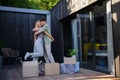 Cheerful young couple moving in their new tiny house in woods. Conception of moving and sustainable living.