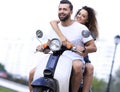 Happy cheerful couple riding vintage scooter. Travel concept. Royalty Free Stock Photo