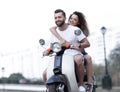 Happy cheerful couple riding vintage scooter. Travel concept. Royalty Free Stock Photo