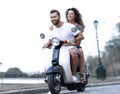 Happy cheerful couple riding vintage scooter. Travel concept. Royalty Free Stock Photo