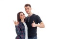 Cheerful young couple standing together smiling and show hands gestures Royalty Free Stock Photo