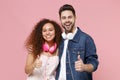 Cheerful young couple two friends european guy african american girl in casual clothes with headphones posing isolated Royalty Free Stock Photo