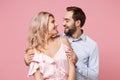 Cheerful young couple two guy girl in party outfit celebrating isolated on pastel pink background. People lifestyle Royalty Free Stock Photo