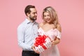 Cheerful young couple two guy girl in party outfit celebrating posing isolated on pastel pink background. Valentine`s Royalty Free Stock Photo