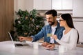 Cheerful young couple using online banking