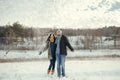 Cheerful young couple walking in a winter day