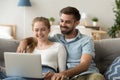 Cheerful young couple watching movie at home Royalty Free Stock Photo
