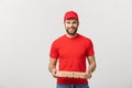 Cheerful young deliveryman holding pizza boxes while isolated on white studio background