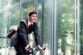 Cheerful young employee riding an utility bicycle in Berlin