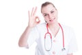 Cheerful young female doctor smiling and gesturing ok Royalty Free Stock Photo