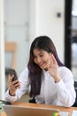 Young female having video call on smart phone with her friend. Royalty Free Stock Photo