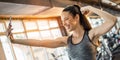 Cheerful young fit woman taking a selfie photo using her smartphone and showing muscles in gym. Royalty Free Stock Photo