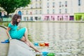Cheerful young French woman having fun on Saint-Martin canal