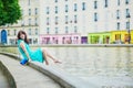 Cheerful young French woman having fun on Saint-Martin canal